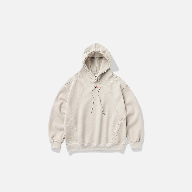 Front view of the beige Zen Mod Hoodie in a gray background