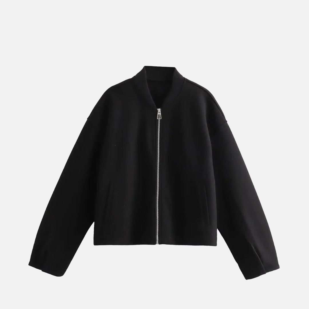 Front view of the black Ethereal Quilted Embrace Jacket in a gray background