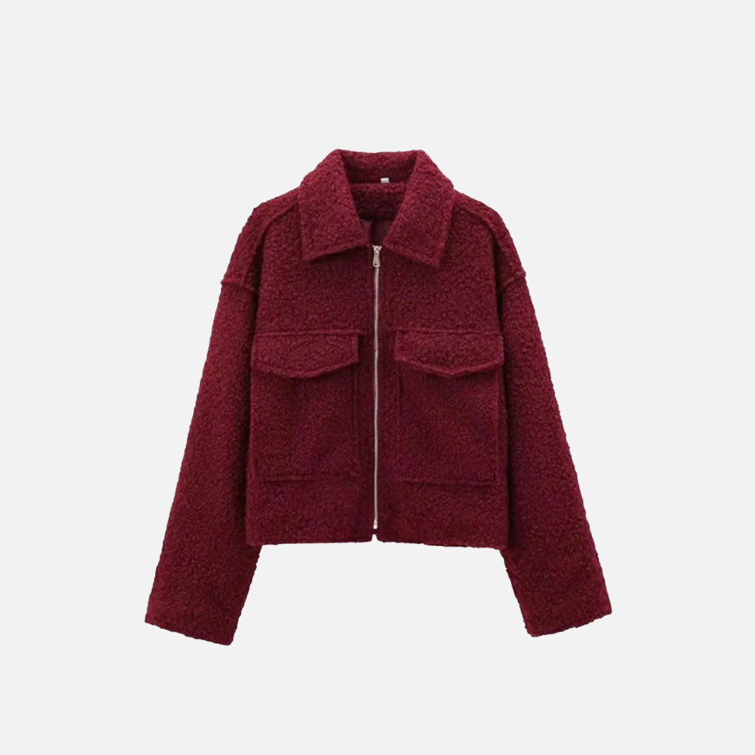 Front view of the red Quilted Utility Jacket in a gray background